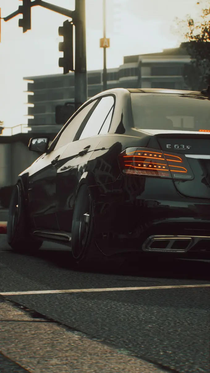 A black Mercedes executive saloon at dusk, tail lights lit, on a city street