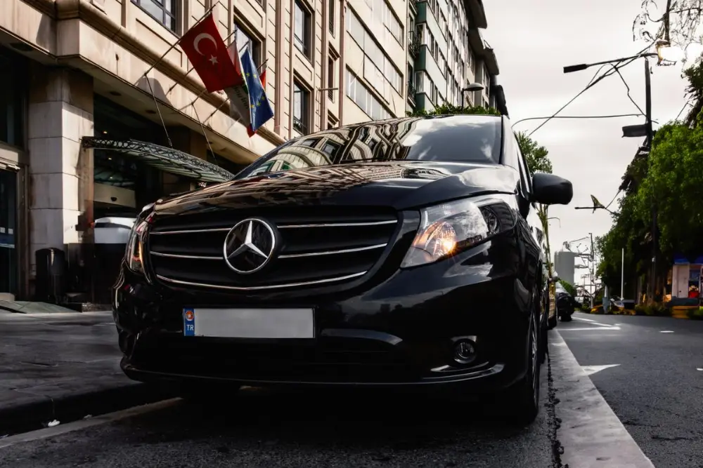 A black Mercedes-Benz V-Class people carrier, the seven-seater for groups and luggage